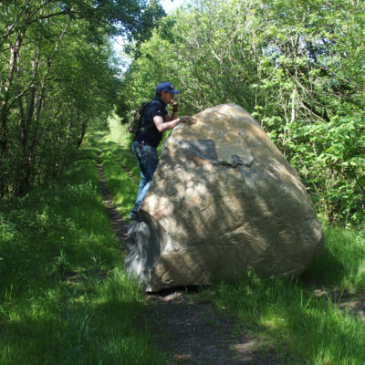 photo of a man stood infront of a rock